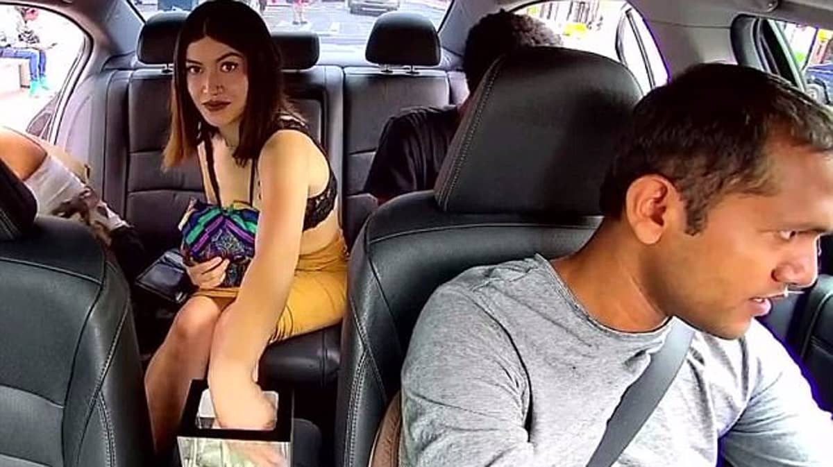 The woman looked straight into the camera of the Uber driver as she took mo...