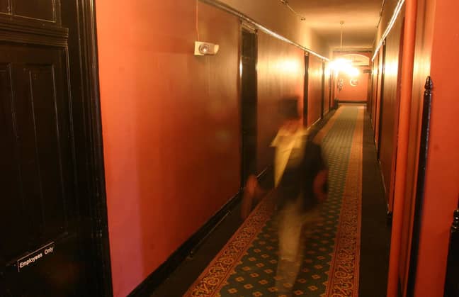 A ghoulish figure treads the hallways (actually just a dude in a top hat shot with a slow shutter speed). Credit: PA