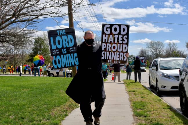 Members of the Westboro Baptist Church display their well known hate signs. Credit: PA