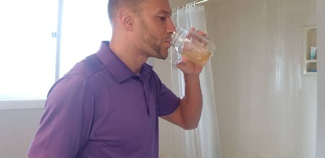 John DePass drinking his own urine as part of a strict diet. Credit: Kennedy News and Media