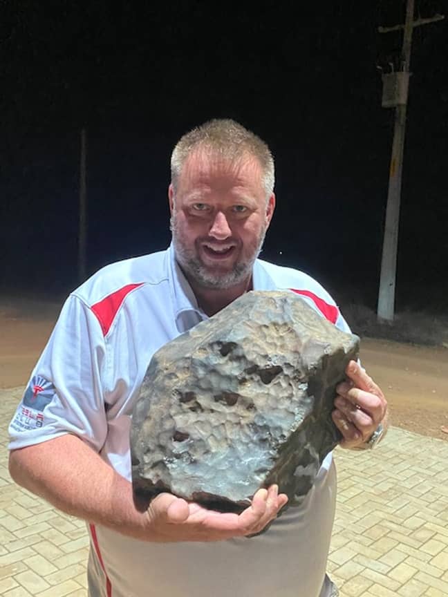 Michael Farmer holding the 38.2kg piece of meteorite. Credit: Michael Farmer