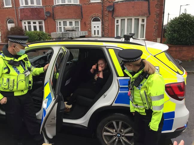 The 15-year-old was allowed to hop in the car and turn on the sirens. Credit: SWNS
