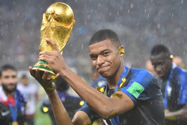 Mbappe with World Cup trophy. Credit: PA