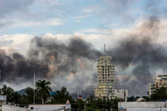 Smoke from burning cars rises due in Culiacan, Mexico. Credit: PA