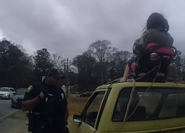 The police stopped Borat after someone reported seeing a woman strapped to the top of his car. Credit: Lilburn Police Department