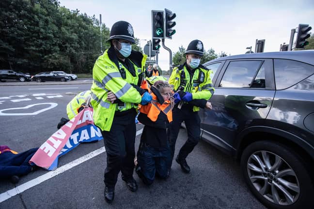Insulate Britain activists are removed by police. Credit: Alamy