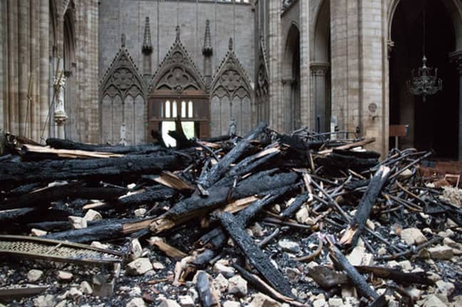A picture taken on April 16, 2019 shows the altar surrounded by charred debris inside the Notre-Dame Cathedral. Credit: PA