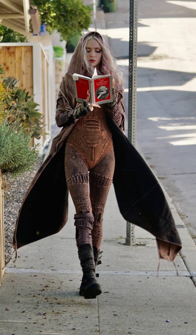 Just casually walking and reading a bit of Marx. Credit: Backgrid