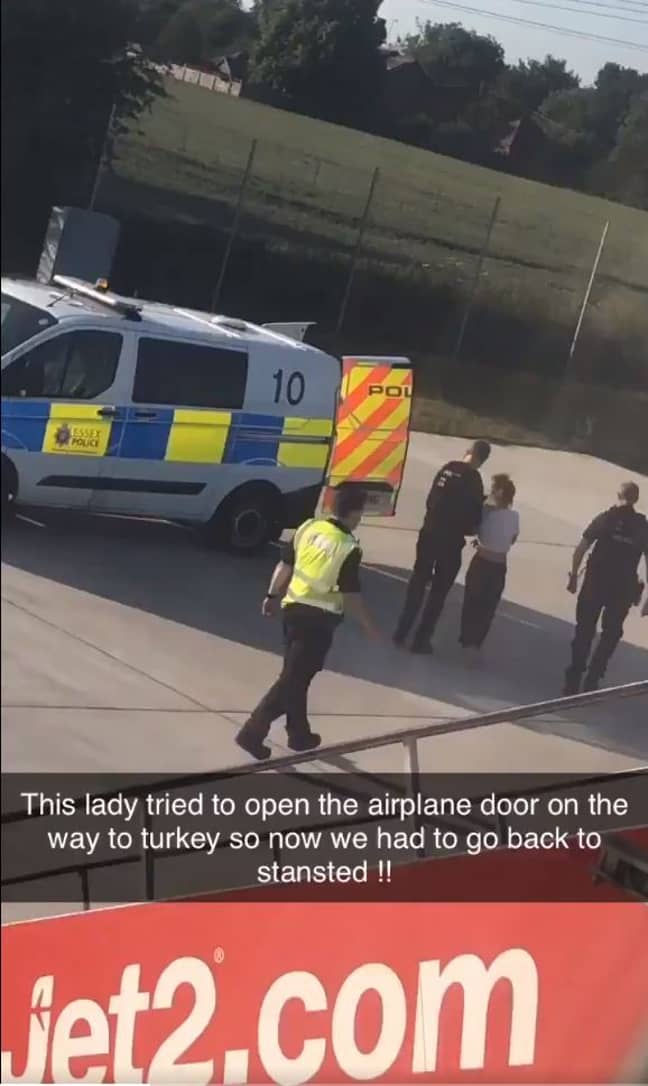 The woman was escorted from the flight by police. Credit: Amiy Varol