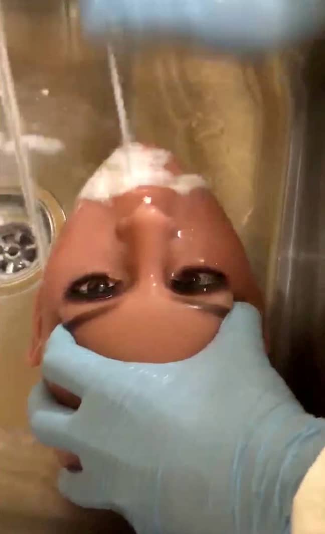 A doll quite literally having her mouth washed out. Credit: SWNS