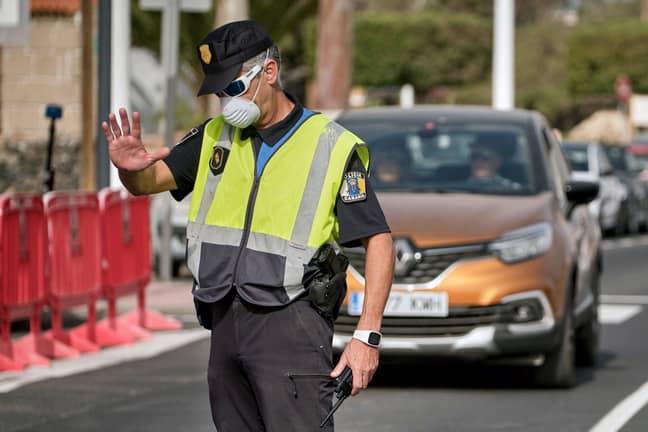 A police officer controls the road to the H10 Costa Adeje Palace hotel in Tenerife. Credit: PA