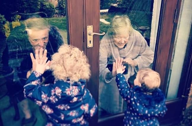 Ray and Theresa embrace their great-grandchildren. Credit: Supplied