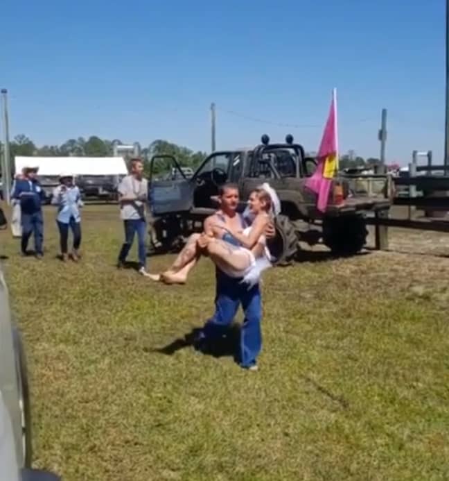 Jeremy then scooped up his bride and took her to a muddy patch to frolic around. Credit: Storyful