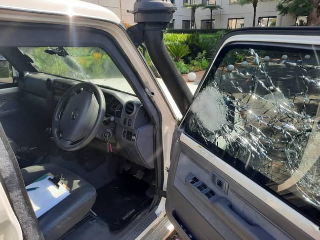 The car's window shattered by bullets. Credit: Twitter