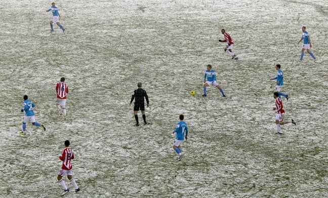 A Premier League fixture in the snow. Credit: PA