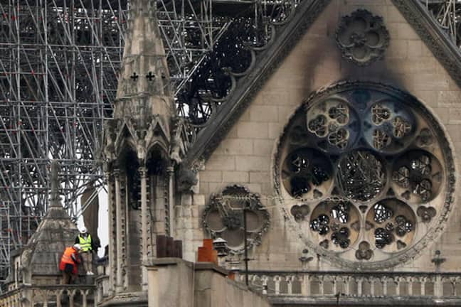 Experts inspect the damaged Notre Dame cathedral after the fire in Paris. Credit: PA