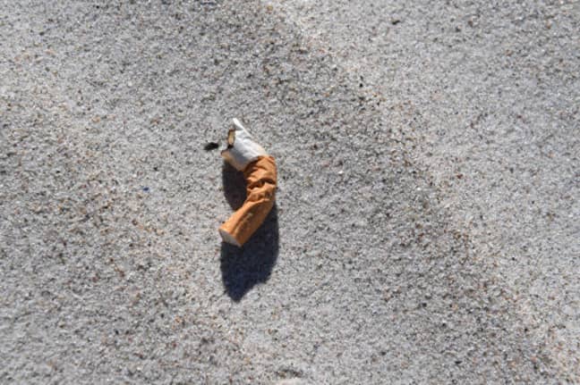 A cigarette butt lying on the beach. Credit: PA