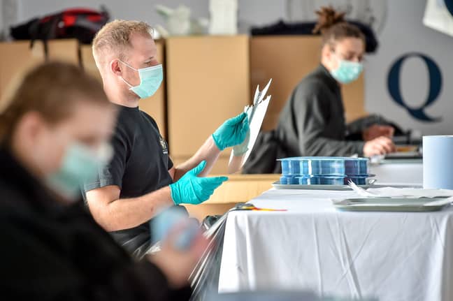 Royal Mint employees making PPE in the cafe of the tourist attraction. Credit: PA