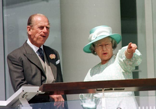 The Queen and the Duke of Edinburgh watch the racing at Epsom in 1997. Credit: PA