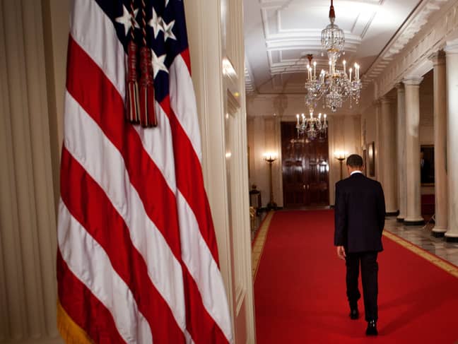 President Obama walks through the Cross Hall of the White House after sharing the news on 2 May 2011. Credit: PA
