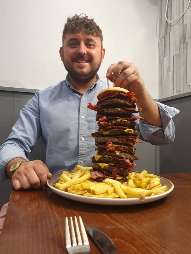 Pub owner Craig Harker with that monstrous burger. Credit: SWNS