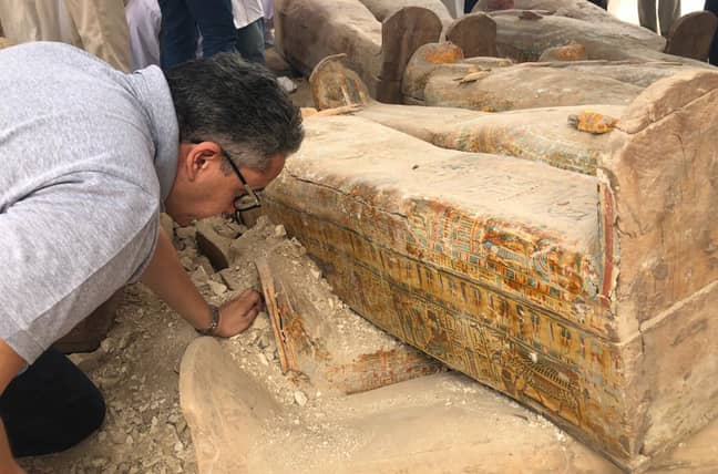 Egyptian Minister of Antiquities, Khaled el-Anany, inspecting the coffins. Credit: PA