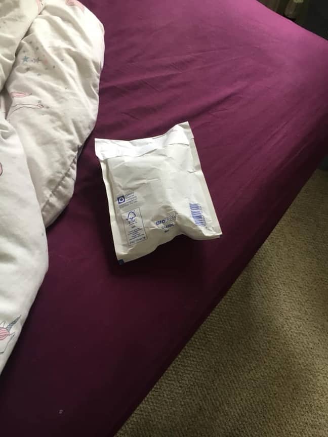 The parcel was successfully thrown through the window and onto the bed. Credit: Laura Chaisty/Facebook