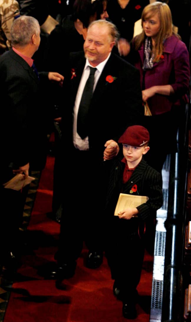 Fin, aged six, at a memorial service for his brother, wearing Jeff's beret. Credit: PA