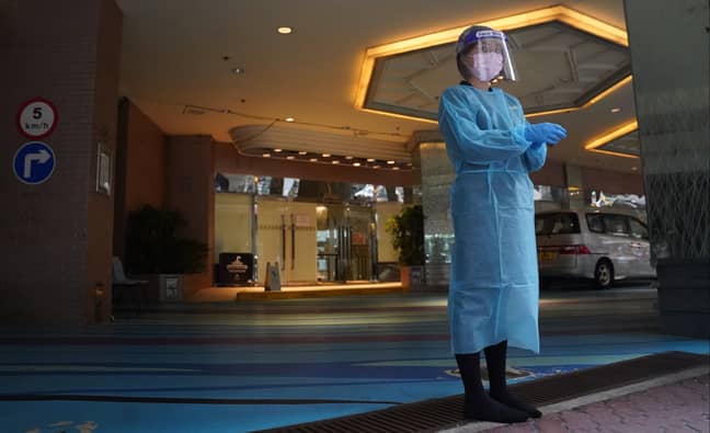 A healthcare worker in Hong Kong ready to accept new arrivals at hotel quarantine. Credit: PA