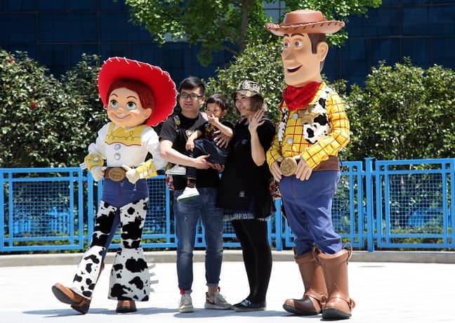 Woody and Jessie pose with a family at Shanghai Disneyland. Credit: PA