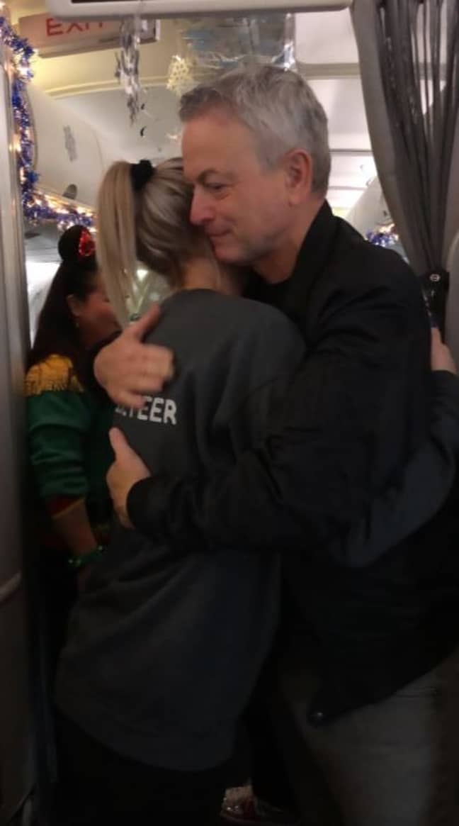 The actor welcoming families on board the plane. Credit: Twitter/Gary Sinise