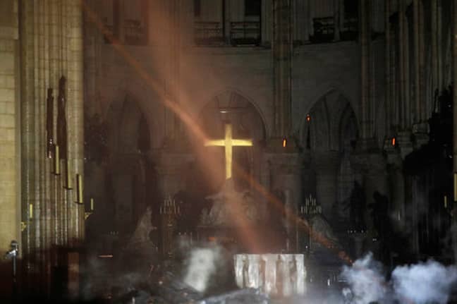 The cross can be seen through the smoke inside the Notre Dame Cathedral. Credit: PA