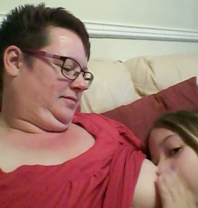 Mum breastfeeds her nine-year-old daughter. Credit: Caters