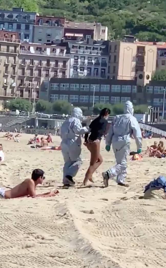 Officers in hazmat suits removed her from the beach. Credit: Solarpix
