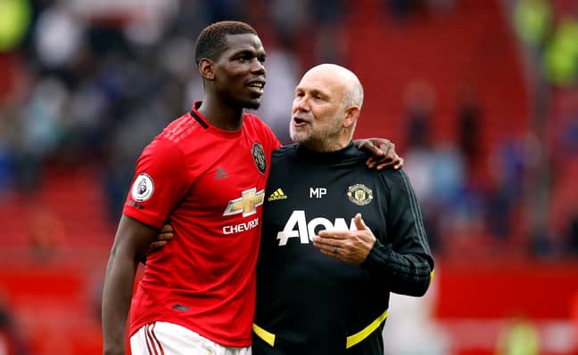 Paul Pogba and Manchester United's assistant manager Mike Phelan. Credit: PA