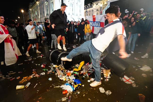 England fans taking their anger out on a bin after the final. Credit: PA