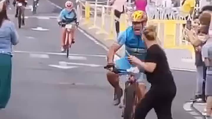 Spectator Taken Out By Cyclist While Sprinting To Finish Line During Race 