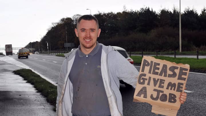 Inventive Unemployed Labourer Finds Work Standing By Motorway With Sign