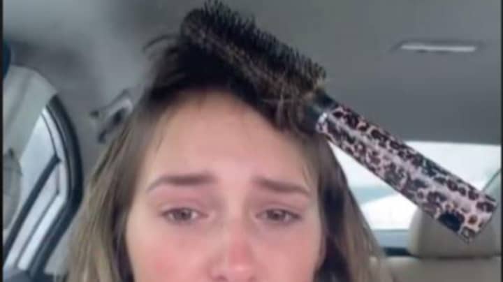 Woman's Attempt At Hair Styling Leaves Her With Hairbrush Stuck To Head