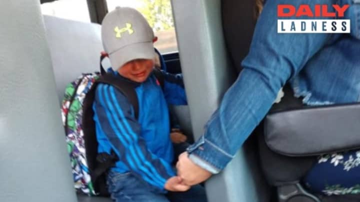 Bus Driver Holds Nervous Boy's Hand On First Day Of School