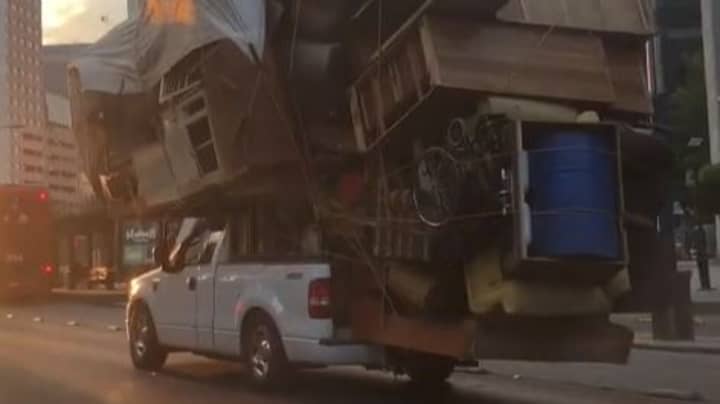 Driver Packs All Belongings Onto Slowly Moving Pickup Truck