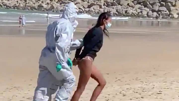 Woman Arrested By Police In Hazmat Suits For Surfing Following Positive Covid-19 Test
