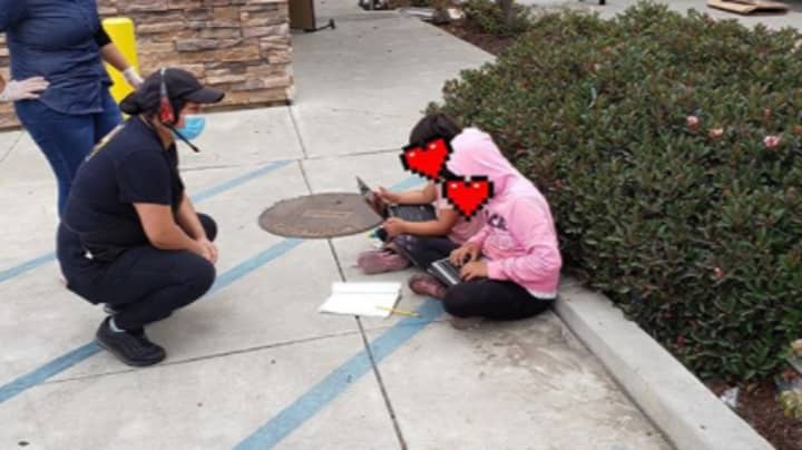 Viral Photo Shows Two Little Girls Using Taco Bell WiFi To Do School Work 