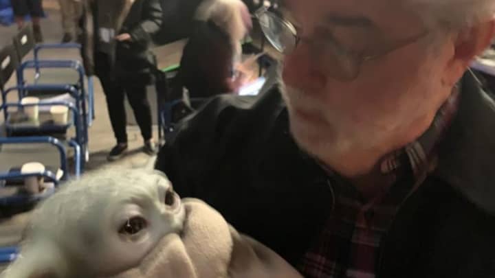 George Lucas Holds Baby Yoda On Set Of Star Wars: The Mandalorian 
