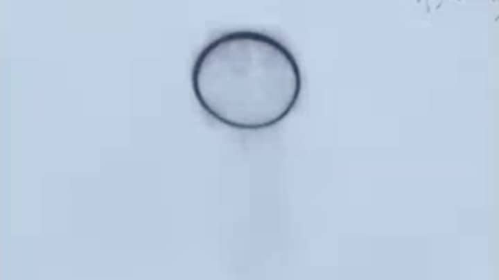Security Footage Captures Black Smoke Ring UFO In Sky