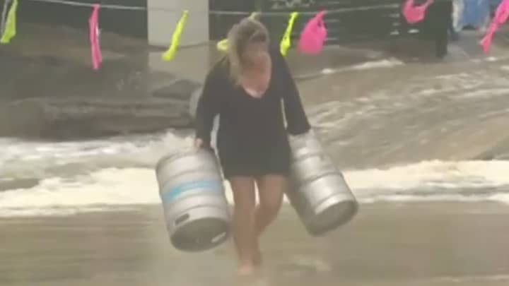 Queensland Woman Jumps Into Ocean To Rescue Beer Kegs During Dramatic Flooding