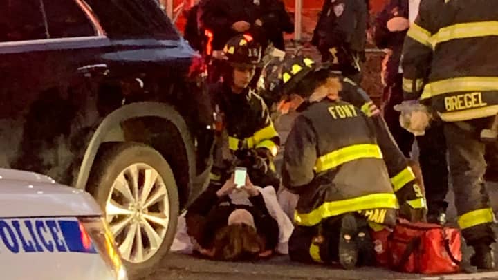 Onlookers Lift Car Off Woman Who Then Goes On Phone While Emergency Services Check Her Over