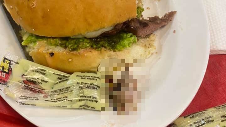 Woman Eating Burger Bites Into Human Finger At Fast Food Restaurant