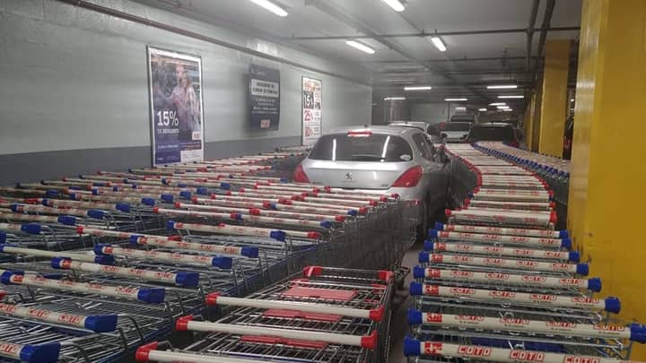 Supermarket Workers Block In Car Parked In Trolley Bay