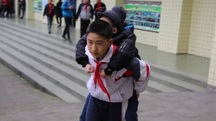 12-Year-Old Chinese Boy Carries His Disabled Friend To School Every Day